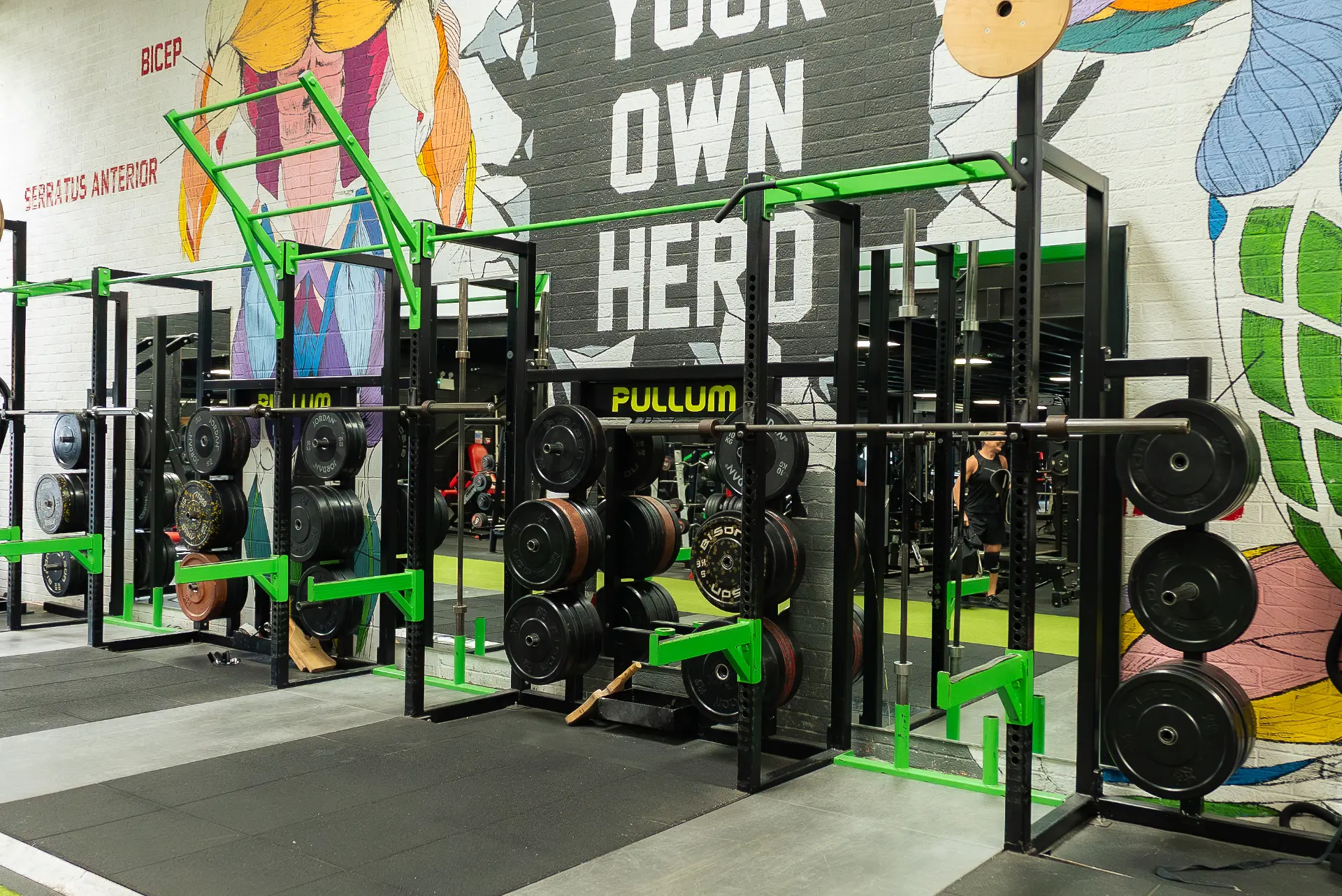 Row of Pullum squat racks in front of the 'Become Your Own Hero' mural at Heros gym, King's Lynn